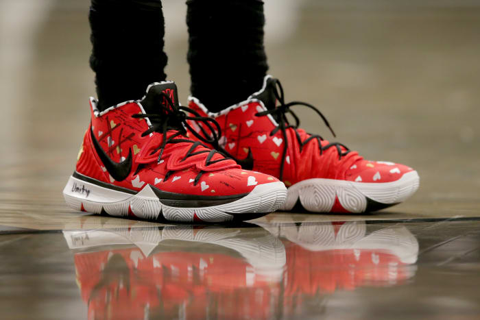 View of Kyrie Irving's red and black Nike shoes.
